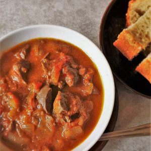 A bowl of chicken livers with a fork.