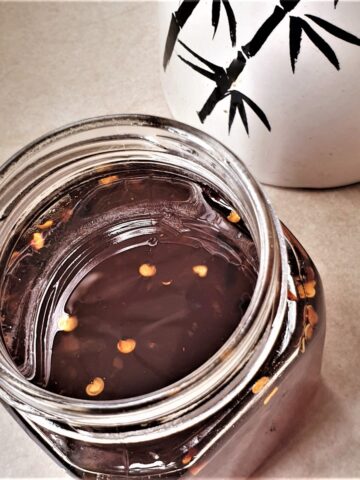 A jar of thai sweet chili sauce.