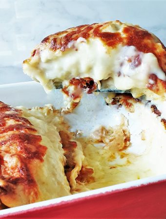 A slice of turkey fajita bake being lifted from the tray.