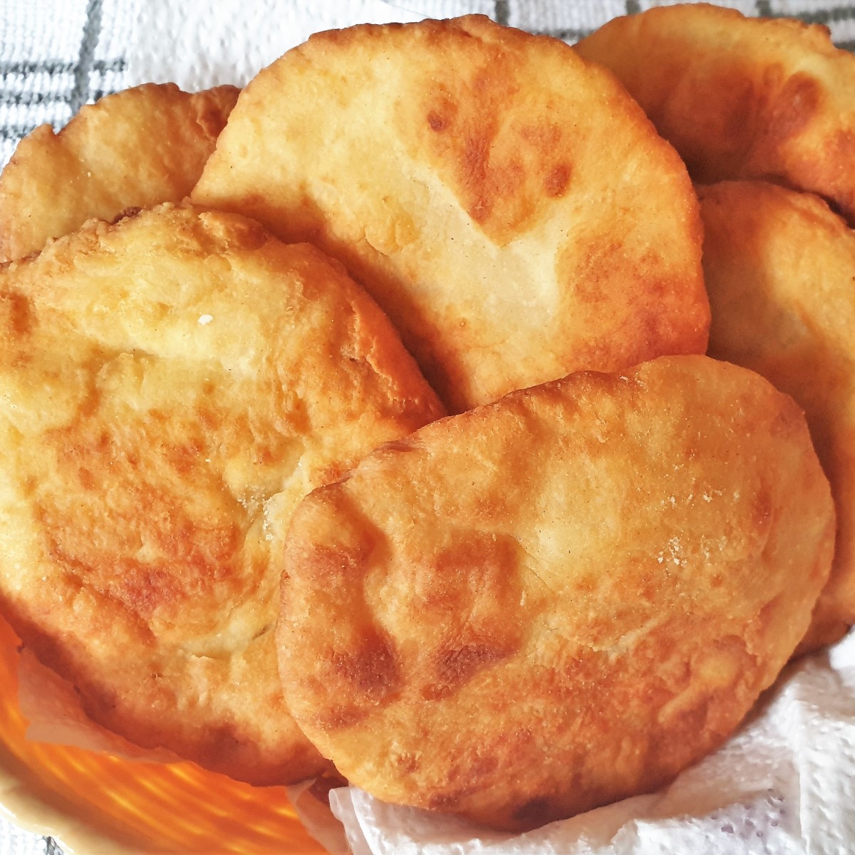 A pile of 2-ingredient vetkoek in a basket.