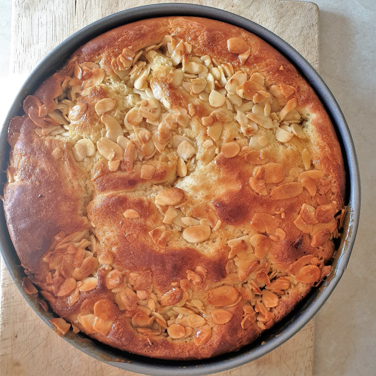 Overhead shot of baked bee sting cake in a baking tin.