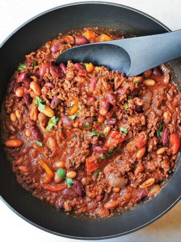 Chilli con carne in a pan with a spoon