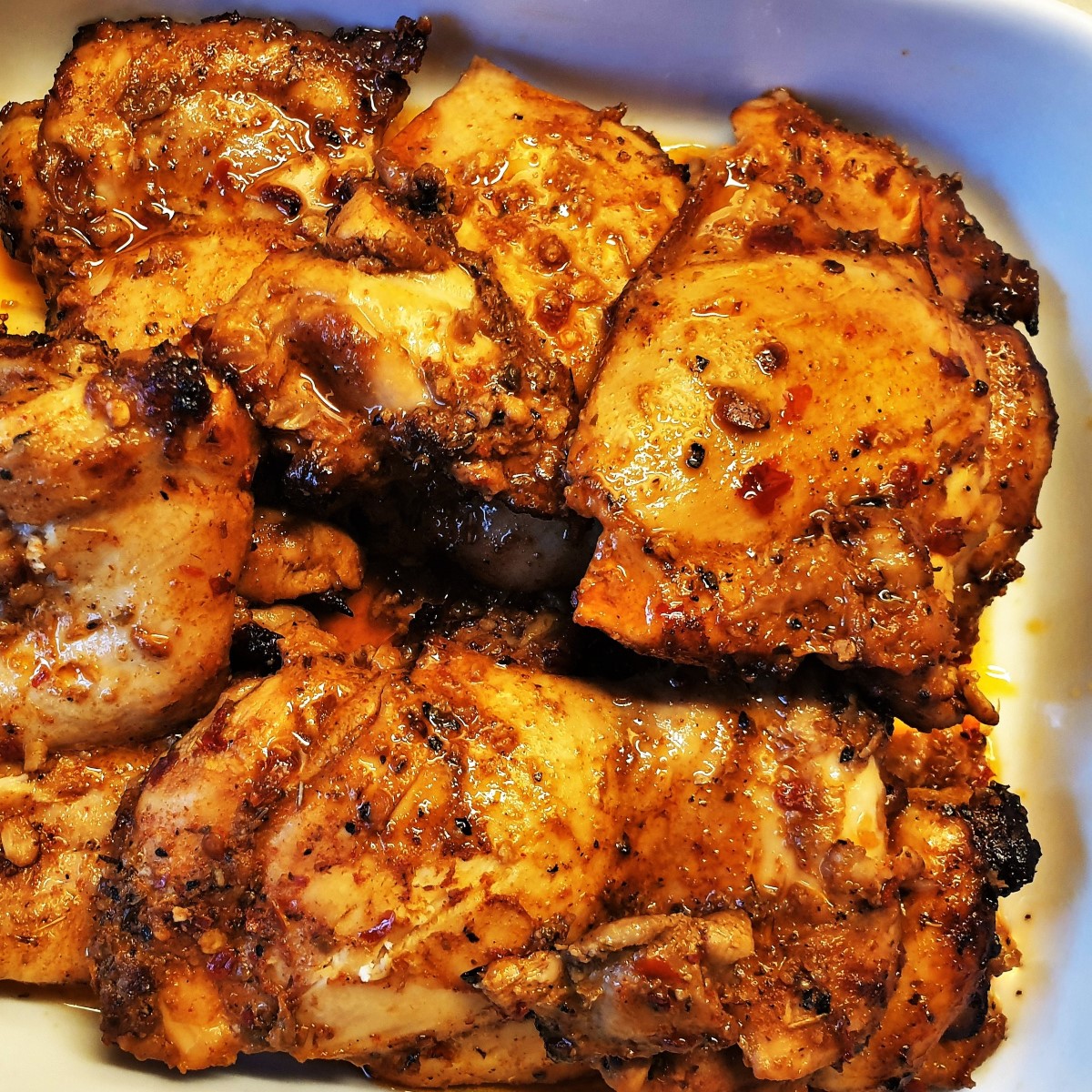 A dish of cooked oven-baked chicken thighs