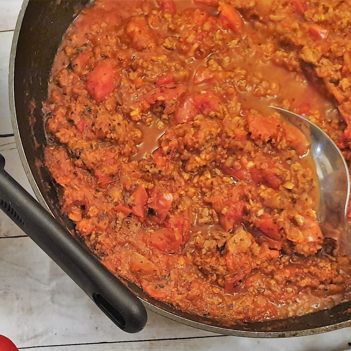 Close up of a pan of spaghetti bolognese sauce.