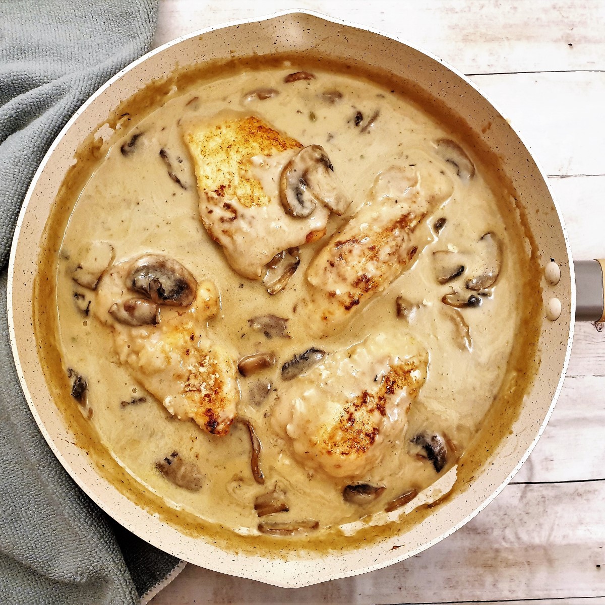 Overhead shot of chicken marsala in creamy mushroom sauce in a frying pan