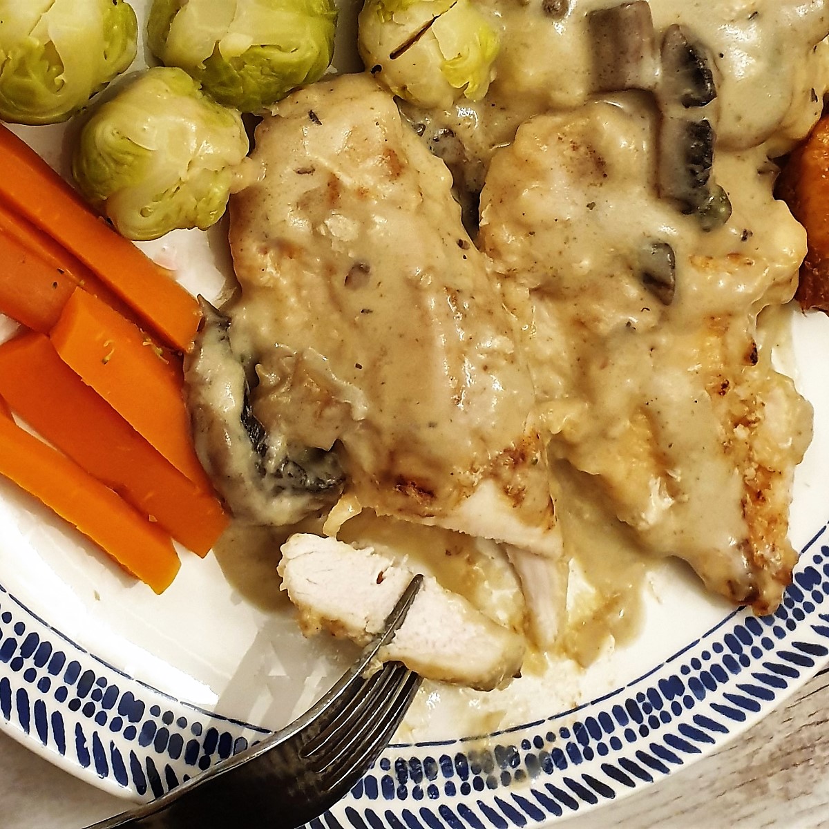 Close up of a piece of chicken marsala showing the inside of the chicken.