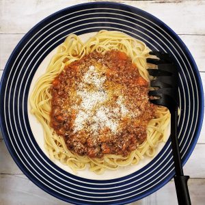 Over head shot of a serving bowl filled with lamb ragu.