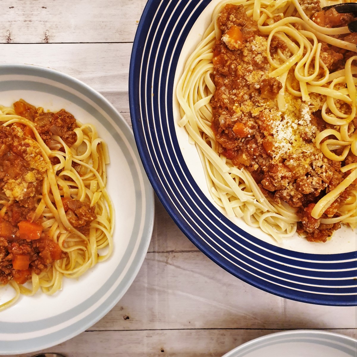 Two bowls of lamb ragu over pasta.