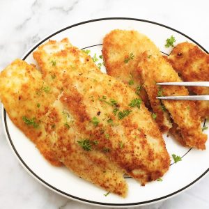 Fried chicken schnitzels on a plate.