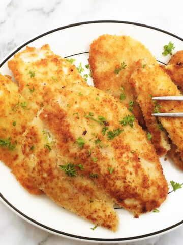 Fried chicken schnitzels on a plate.