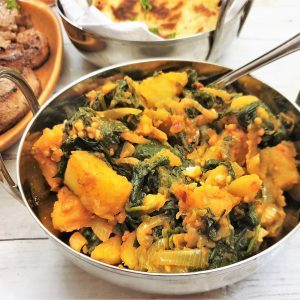 Close up of a balti dish filled with saag aloo.