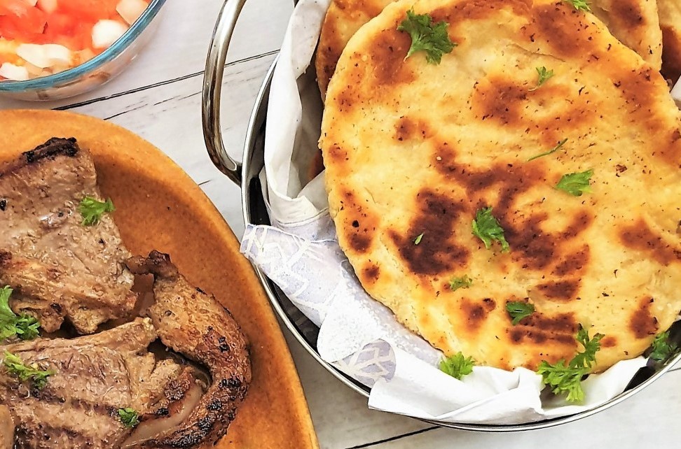 Buttery garlic naan bread in a balti dish.