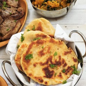 A balti dish filled with buttery garlic naan bread.