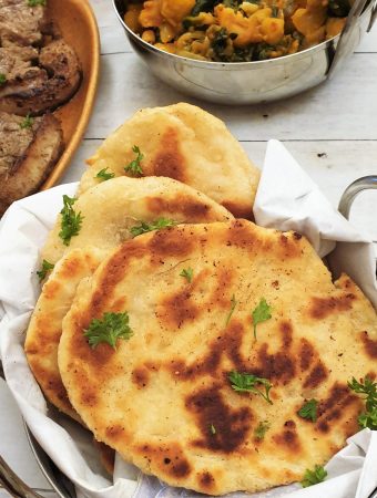 A balti dish filled with buttery garlic naan bread.
