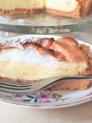 Close up of a slice of key lime pie on a plate.