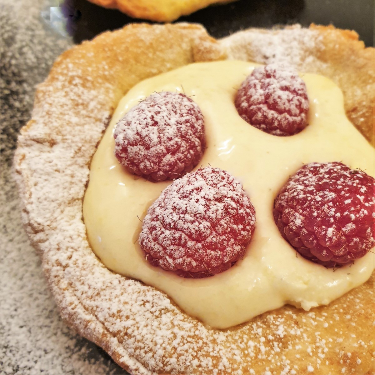 Overhead shot of a raspberry custard tart.