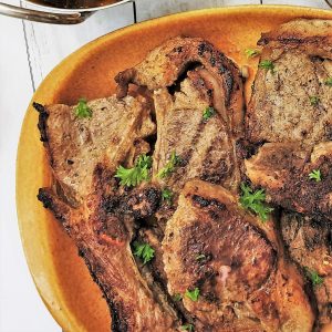 Close up of a plate of tandori lamb chops.