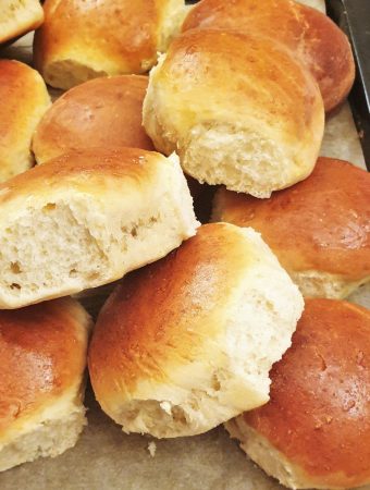A pile of soft dinner rolls.
