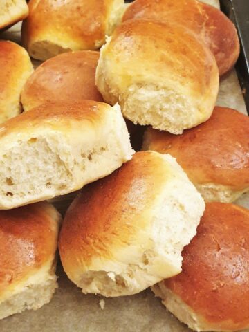 A pile of soft dinner rolls.