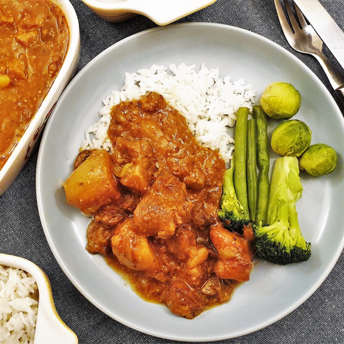 Overhead shot of honey mustard pork casserole on a plate with rice and vegetables.