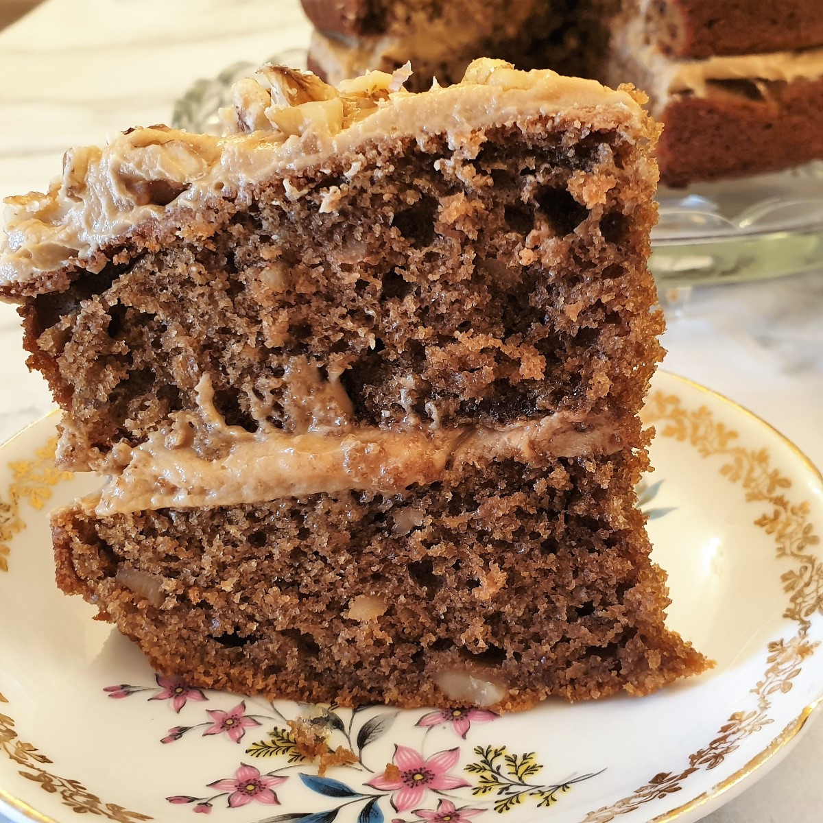 A slice of coffee walnut cake on a plate.