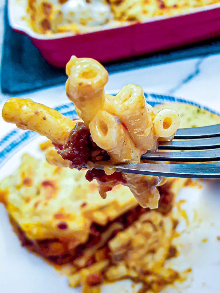 Mac n cheese lasagne on a fork.