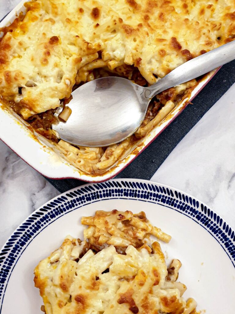 Close up of mac n cheese lasagne with a spoon.