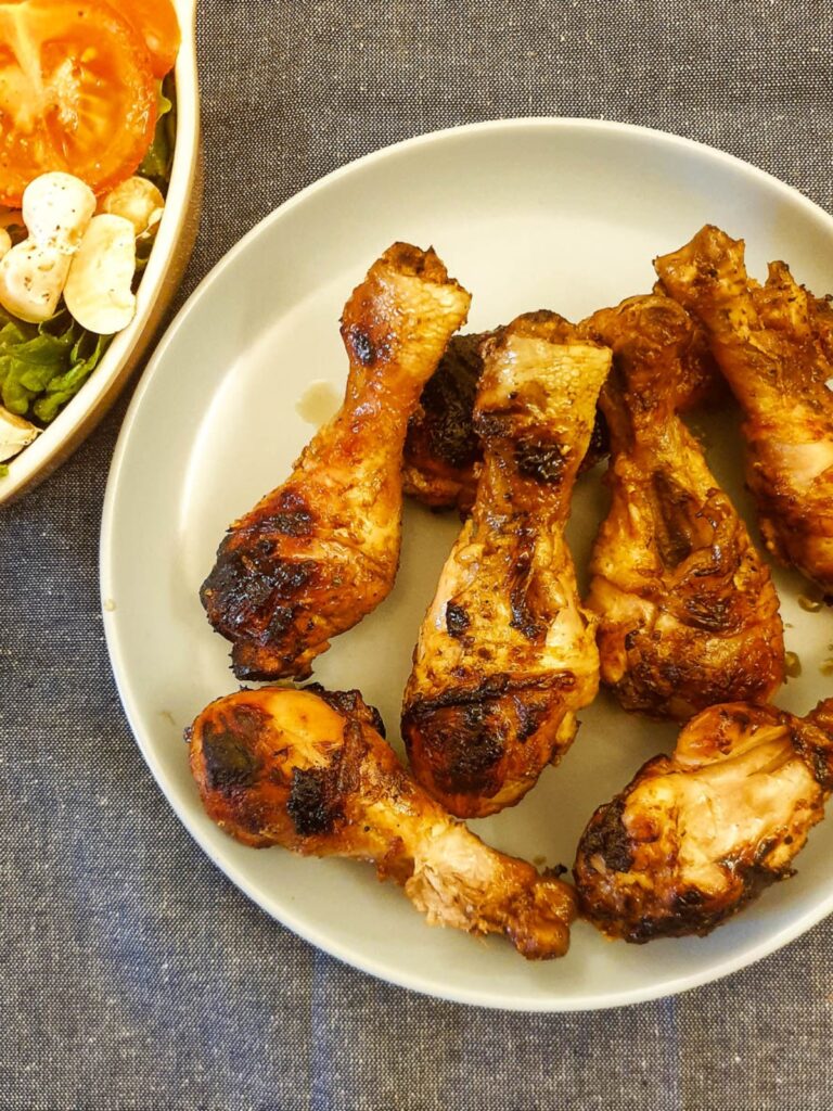 A plate of barbeque chicken drumsticks