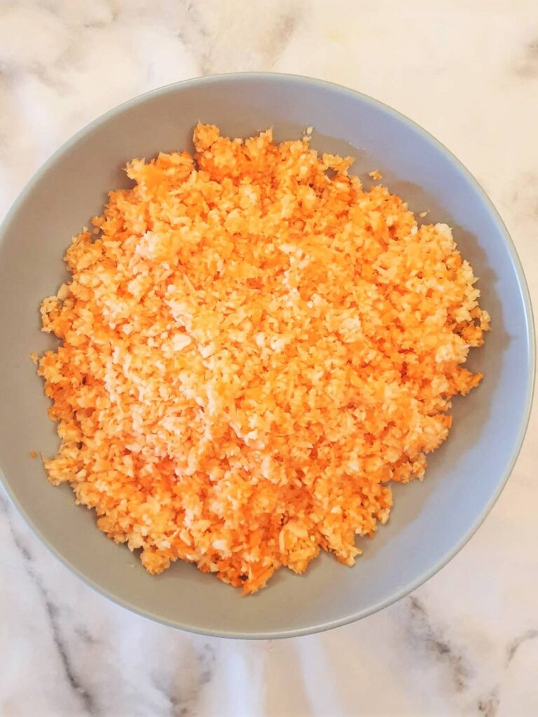 A dish of grated cabbage, carrots and onions ready for the coleslaw dressing.