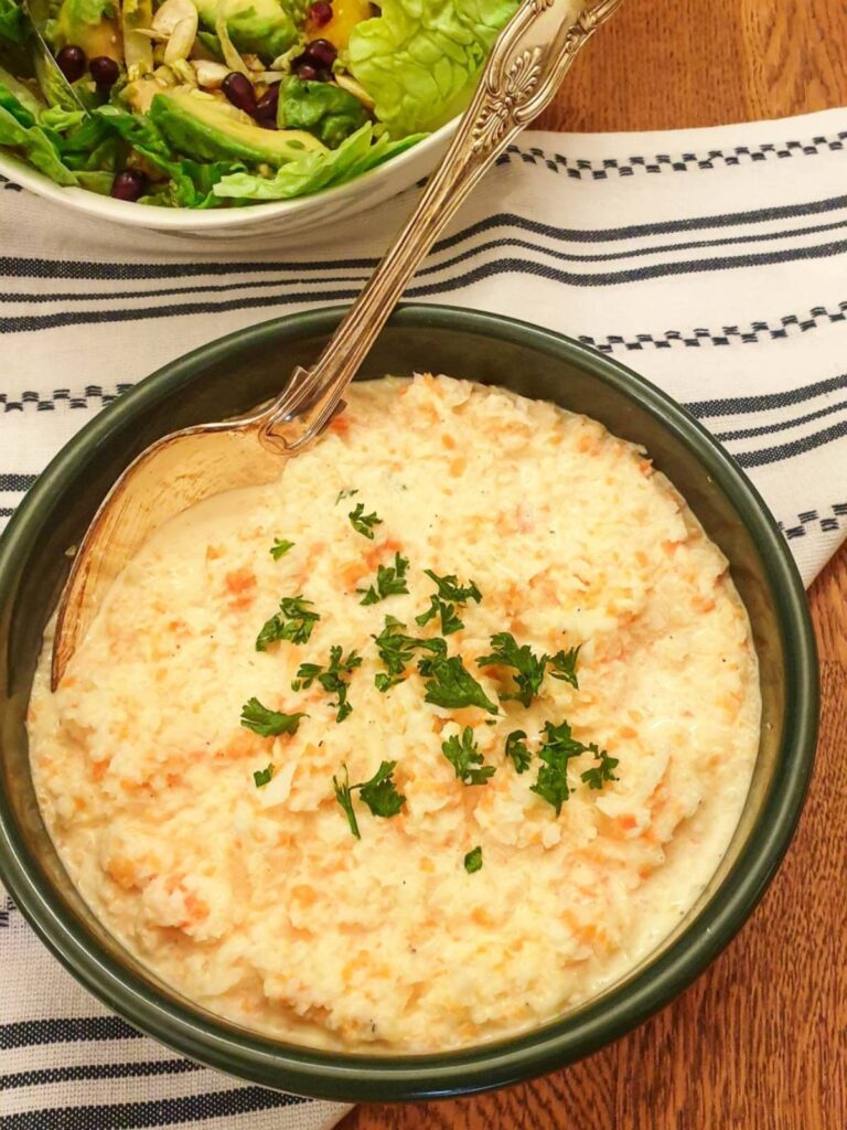 A dish of creamy coleslaw garnished with fresh parsley.