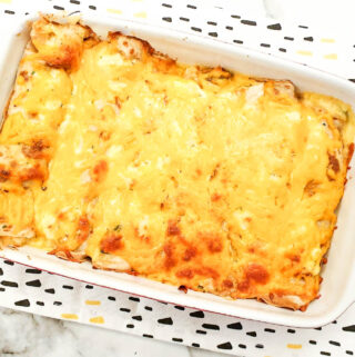 A dish of seafood stuffed pancakes covered with golden melted cheese.