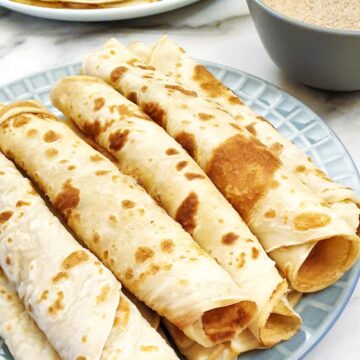 Rolled pancakes on a plate.