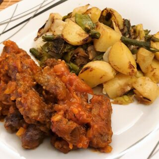 Steak fingers in marinara sauce with a side helping of bubble and squeak.