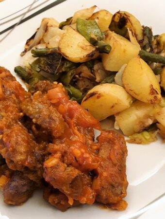 Steak fingers in marinara sauce with a side helping of bubble and squeak.