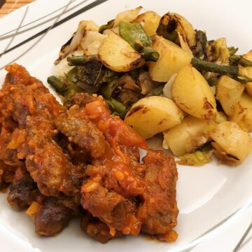 Steak fingers in marinara sauce with a side helping of bubble and squeak.