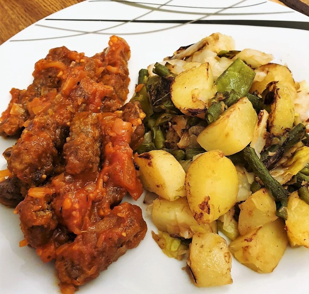 Steak fingers in marinara sauce with a side helping of bubble and squeak.