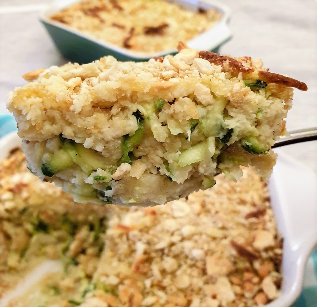 A spoonful of zucchini bake being lifted from the serving dish.