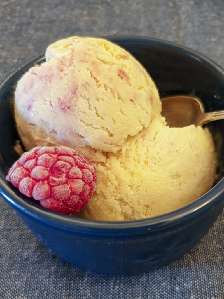 2 scoops of raspberry ripple ice cream in a dish.