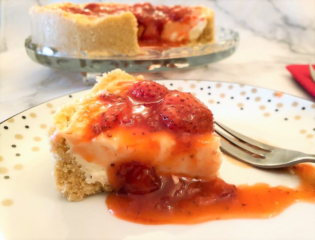 Strawberry cheesecake oozing with syrupy strawberries.