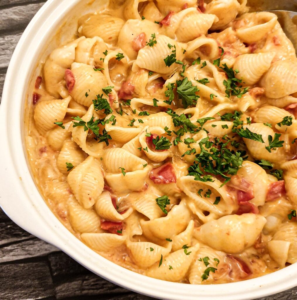 Close up of a dish of cheesy barbeque pasta salad.