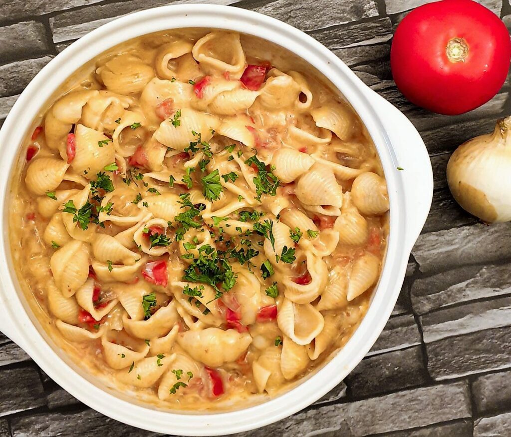 Overhead shot of a dish of cheesy barbeque pasta salad.