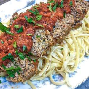 Slices of meatloaf on a bed of pasta, smothered with delicious marinara sauce.