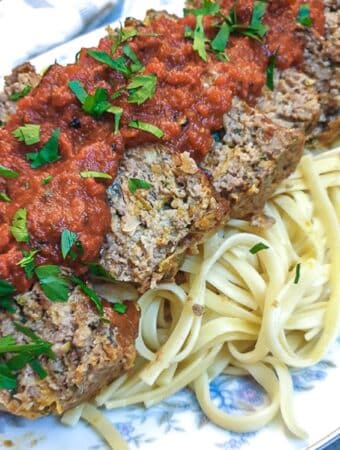 Slices of meatloaf on a bed of pasta, smothered with delicious marinara sauce.