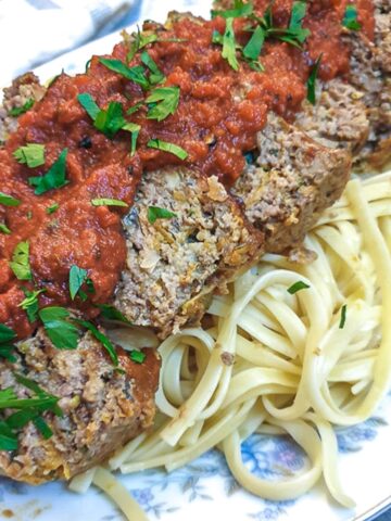 Slices of meatloaf on a bed of pasta, smothered with delicious marinara sauce.