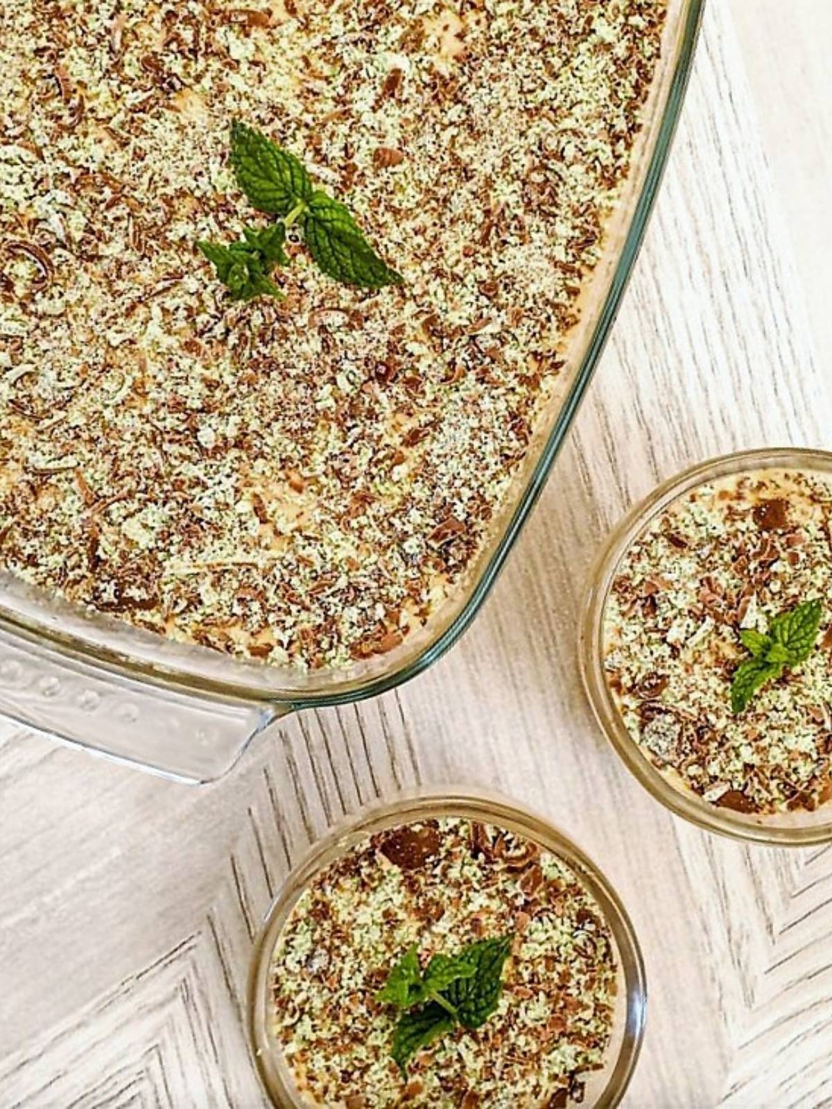 Overhead shot of a dish of peppermint crisp fridge tart next to two smaller individual dishes.