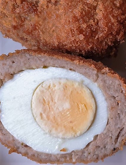 Closeup of the inside of a scotch egg.