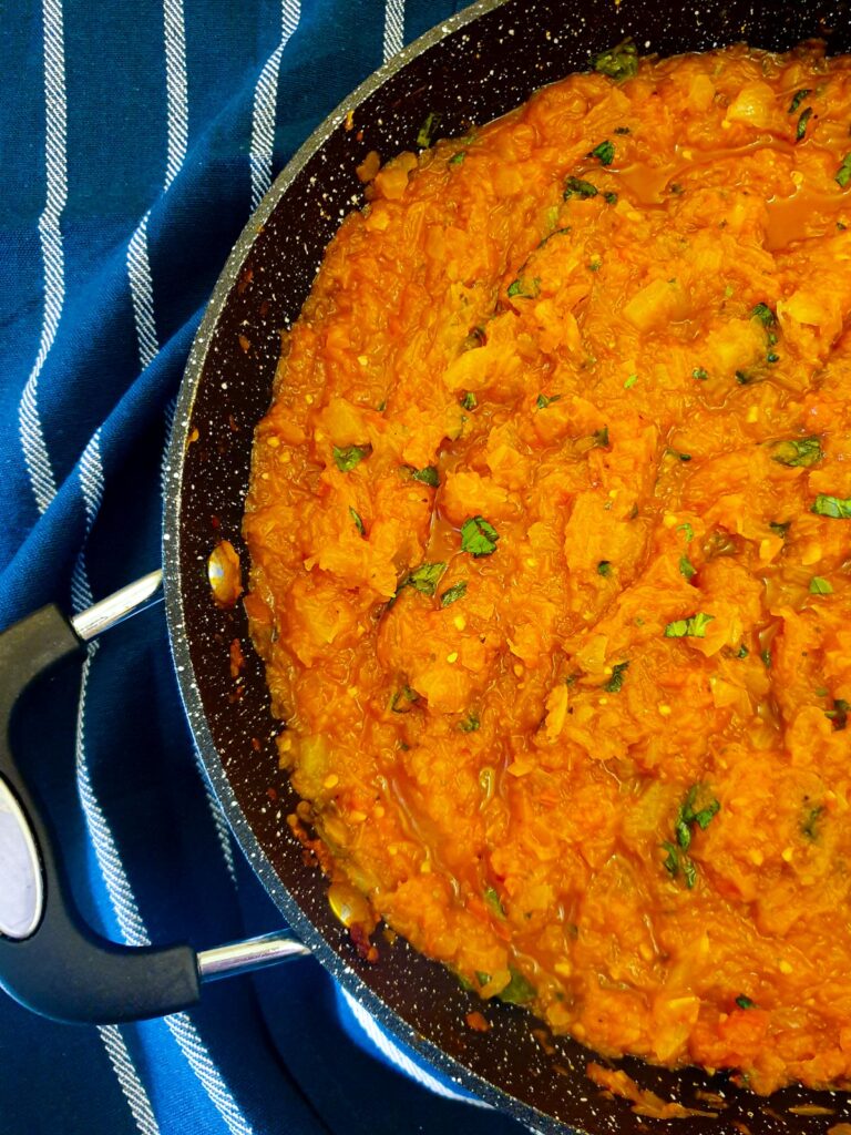 Arrabbiata sauce with marrow in a pan.