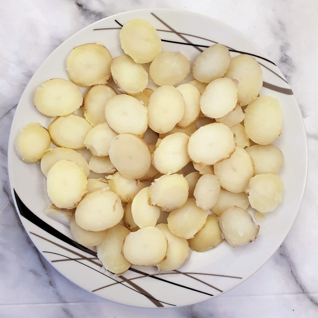 Slices of boiled potatoes on a plate.