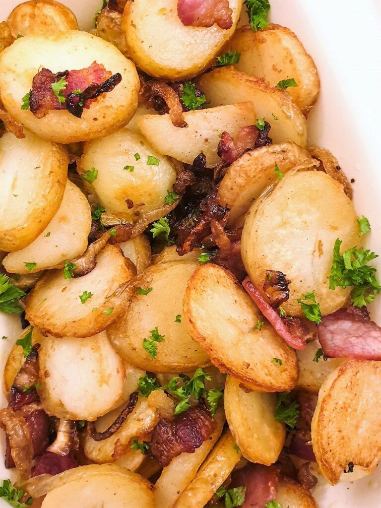 Close up of German fried potatoes with bacon and onion