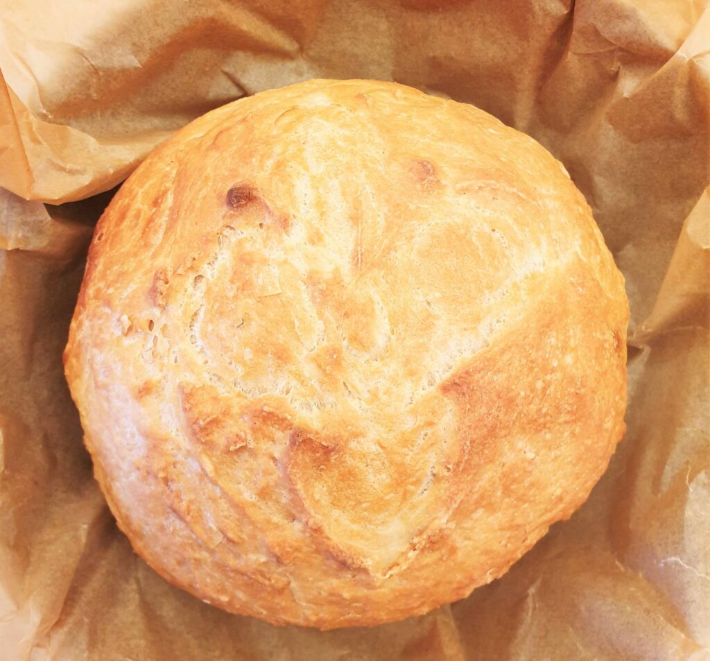 Overhead shot of a homemade loaf of crusty homemade bread.